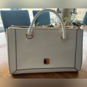 Chic white satchel by MCM. Features elegant gold accents with plenty of room